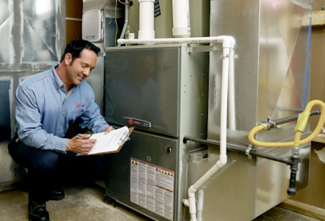 photo of a smiling furnace repair technician going over a checklist