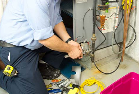 photo of technician working on furnace